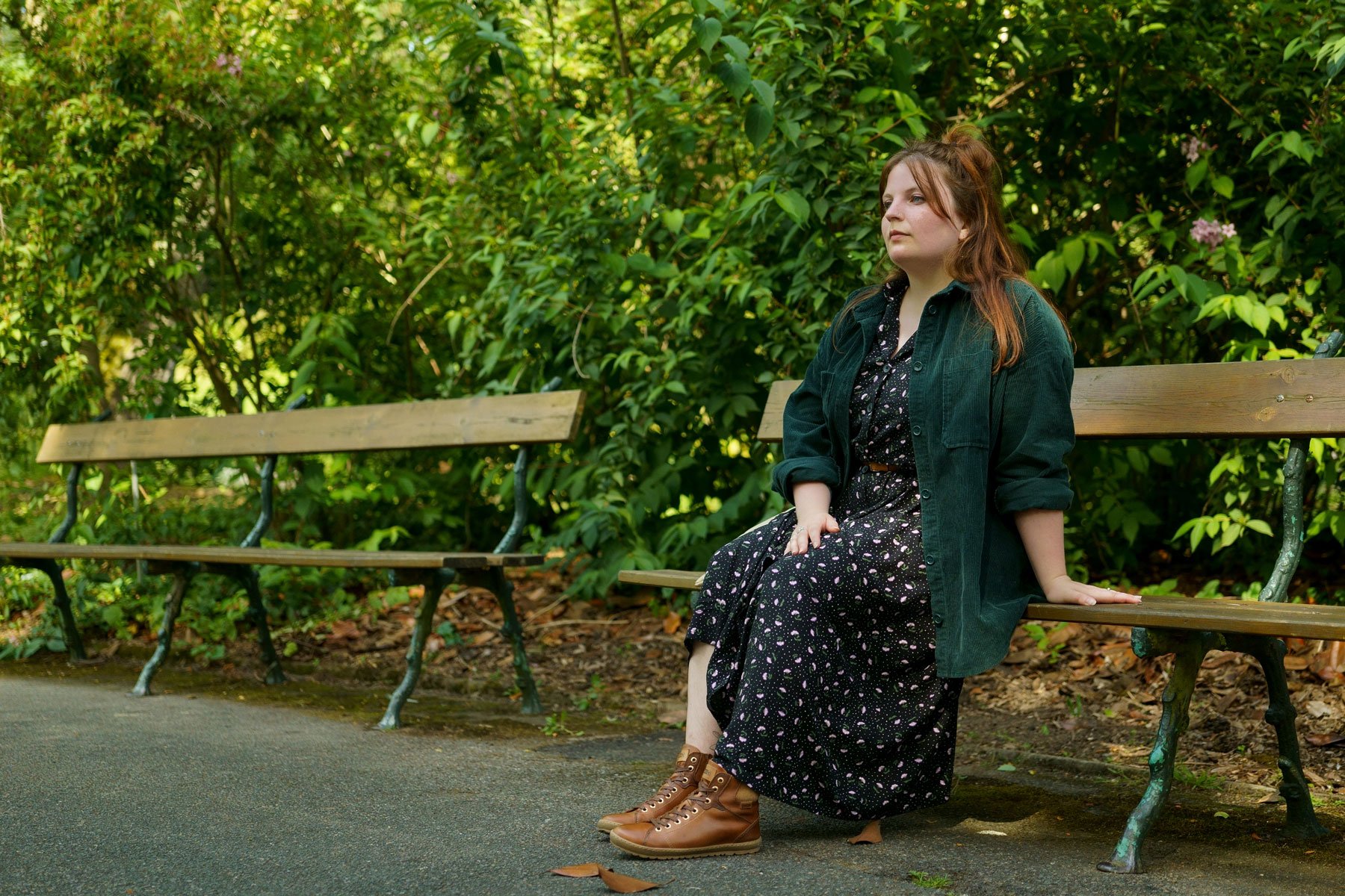 Photograph of Marie on a park bench wearing high-top Pikolinos shoes.