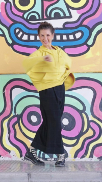 Image of a young woman dancing with Vigo model ankle boots