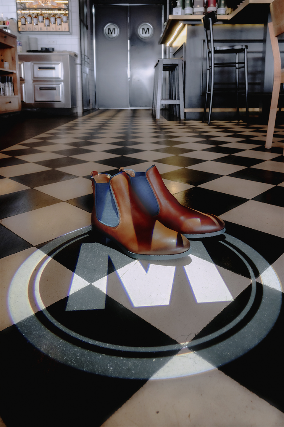 Image of a pair of women's brown ankle boots on the floor of the Moments restaurant