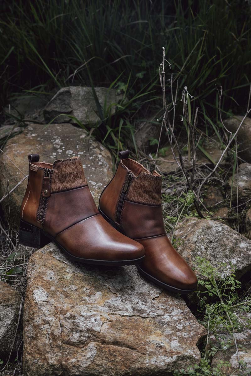 Photograph of a pair of brown Pikolinos women's ankle boots in the mountains