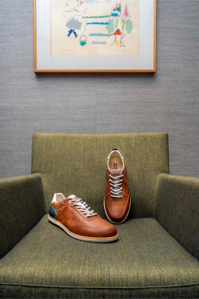 Photograph of brown men's shoes from Pikolinos on an armchair