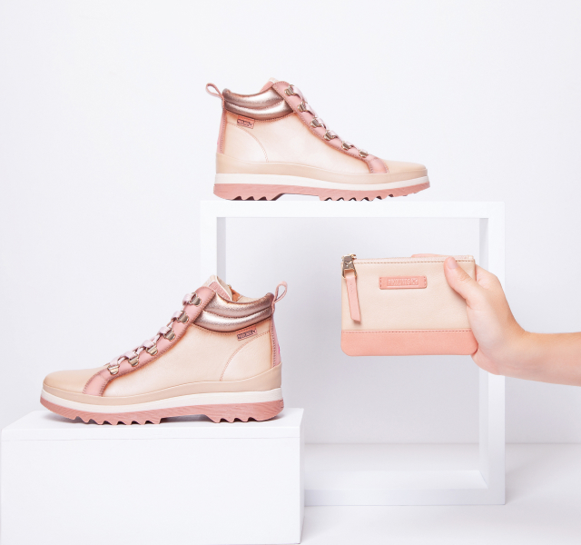 Picture of pink
    ankle boots and purse on a white background