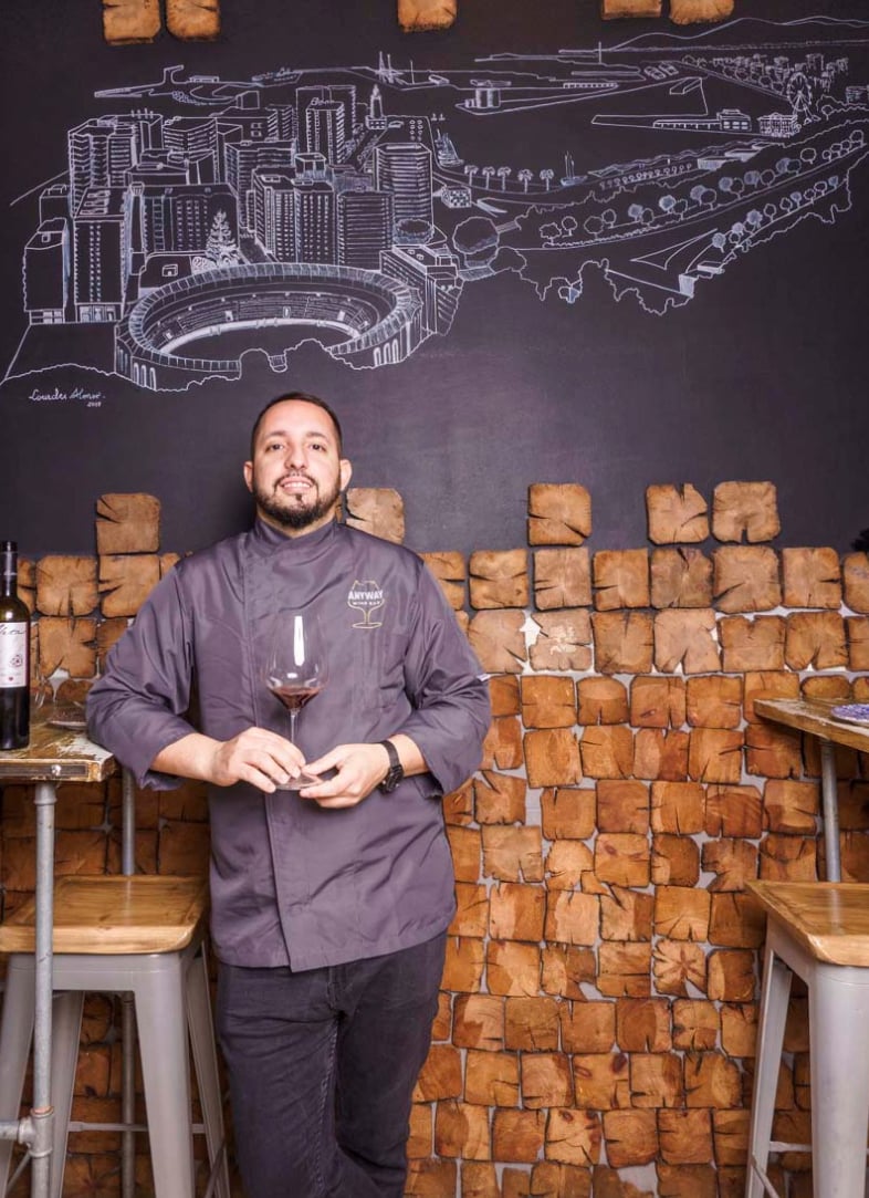 Image of a waiter with a glass of wine at the Anyway Wine Bar