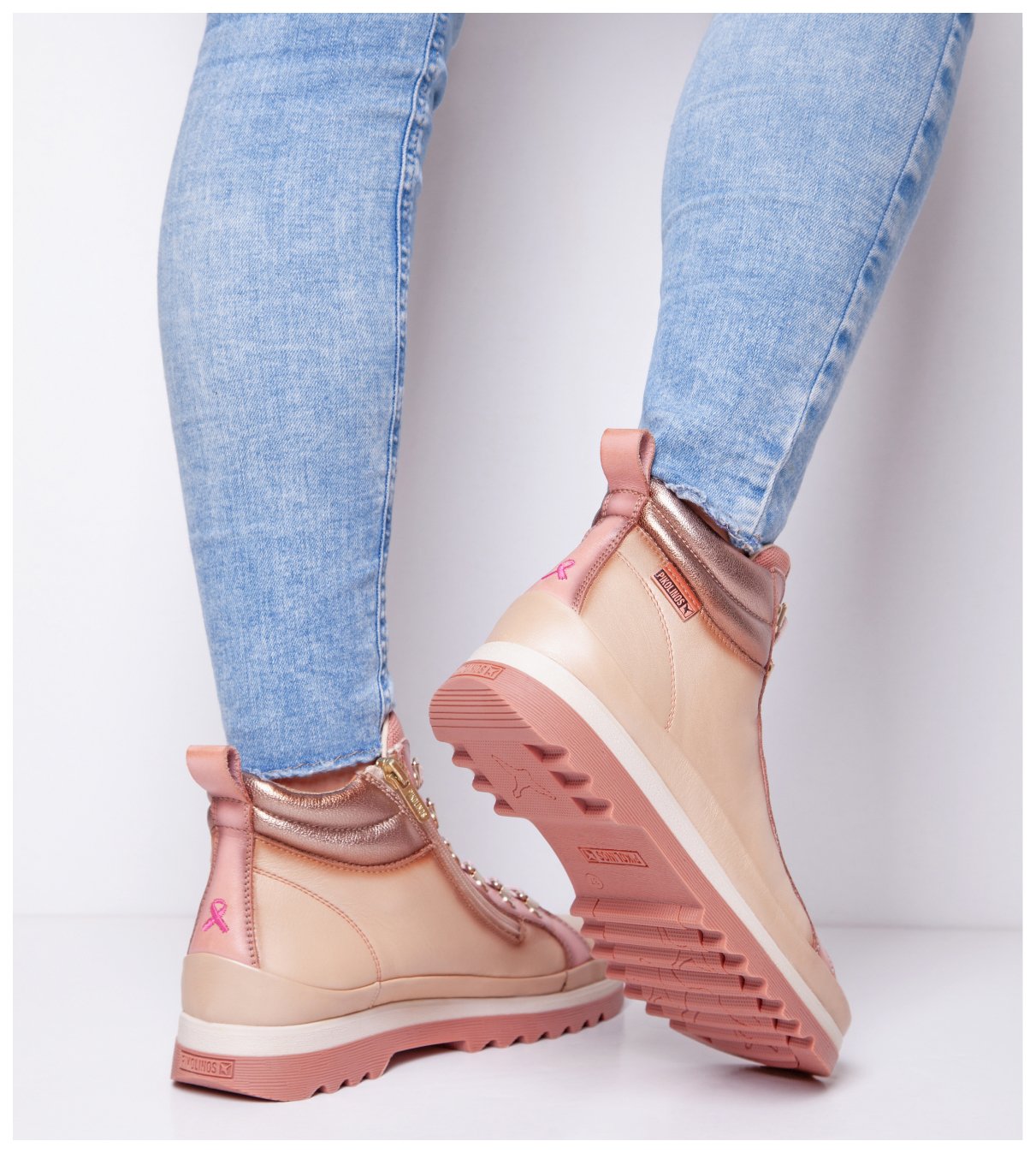 Picture of a
woman's legs with pink Vigo ankle boots from behind