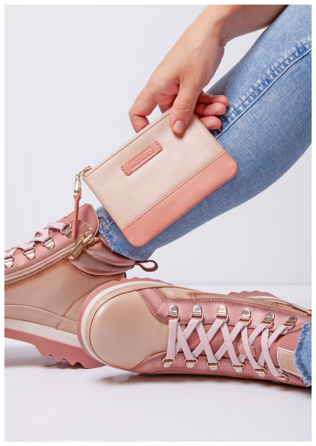 Picture of a woman's legs with pink Vigo ankle boots in the background and pink
purse.