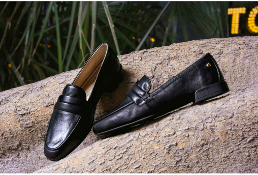 Photograph of black women's loafers on the trunk of a ficus tree