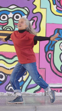 Image of a mature woman dancing with Vigo model ankle boots.