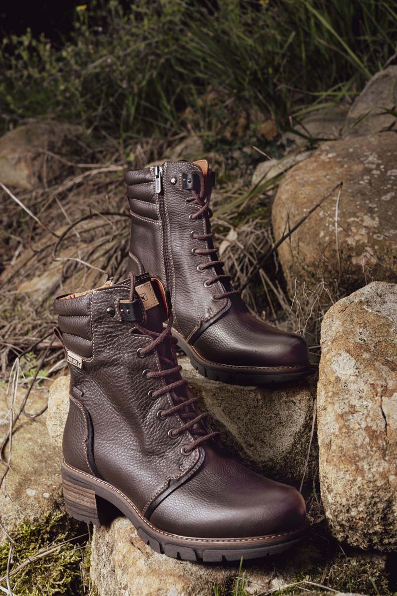 Photograph of a pair of brown Pikolinos women's ankle boots in the mountains