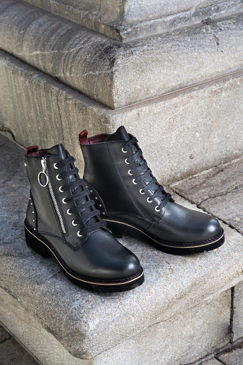 Image of a pair of black Pikolinos women's ankle boots in the street