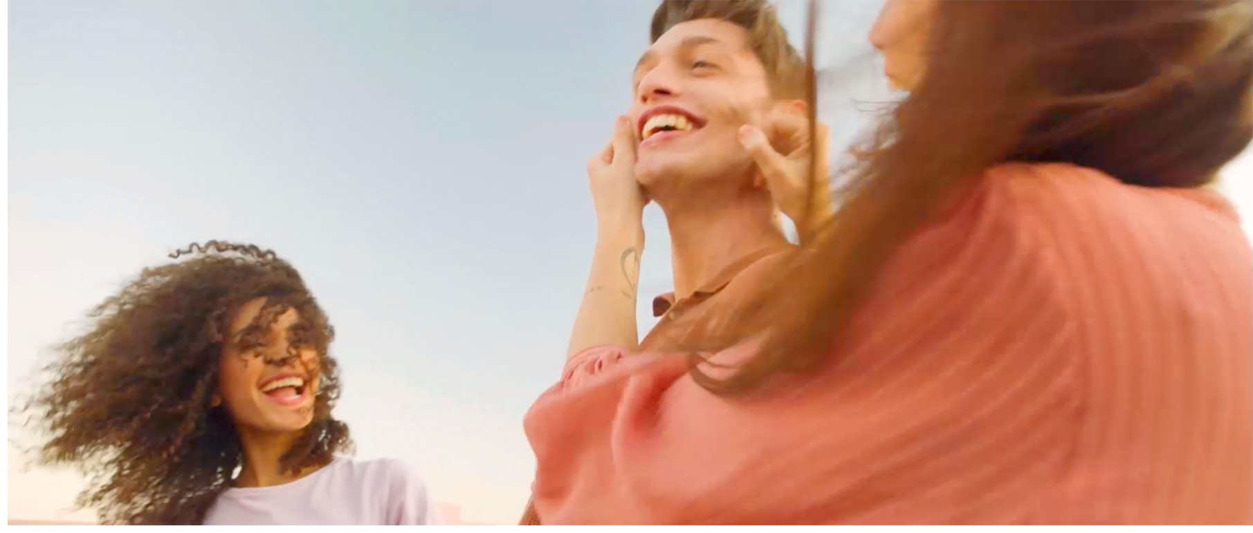 Half-length image of two girls and a boy smiling