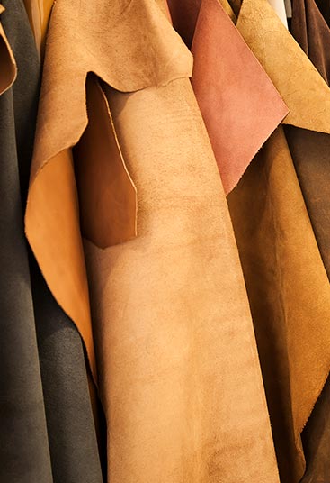 remnants of leather in different colors and the text ‘sustainability in the leather’