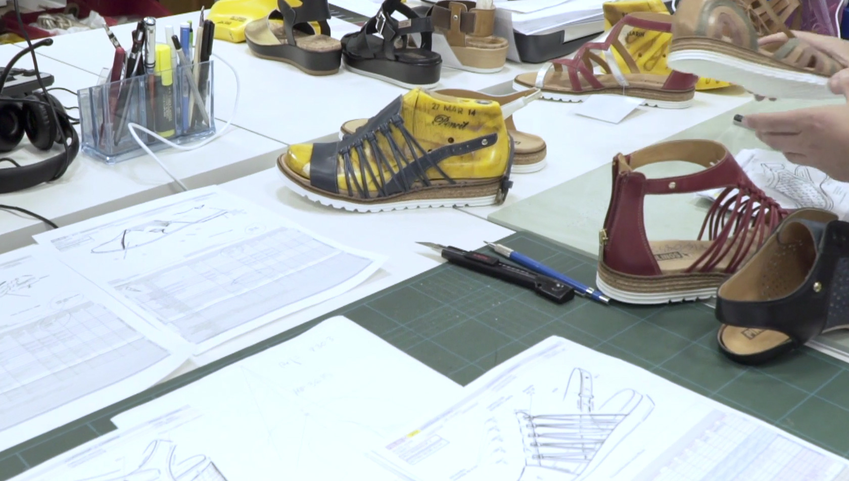 Work table with shoe model design sketches at Pikolinos